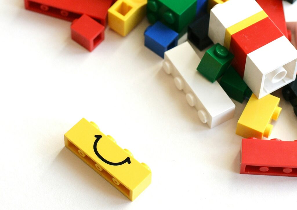 Image of Lego blocks, one of them with a smile
