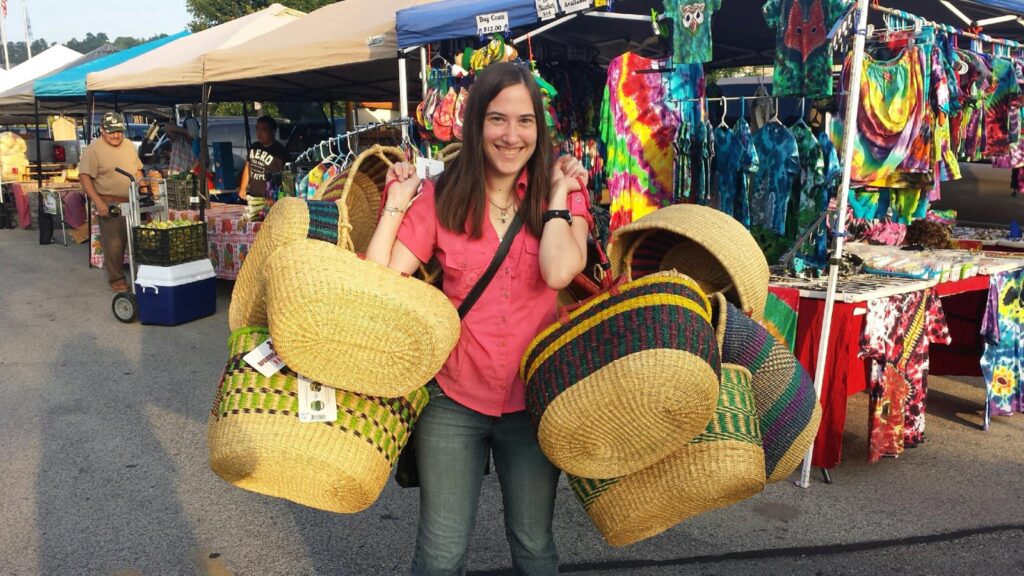 I'm walking through the Waukesha Farmer's Market carrying two armloads of grass-woven baskets from Bolgatanga, Ghana, to sell at Plowshare's Fair Trade booth
